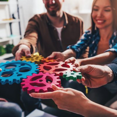 Business team connect pieces of gears. Teamwork and integration concept